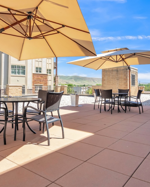outdoor patio with tables covered by umbrellas