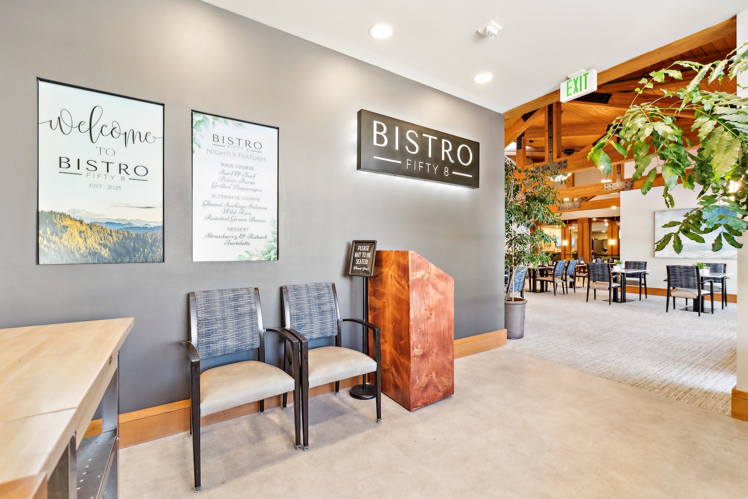 Entrance with signs, chairs, a podium, and view into the dining area