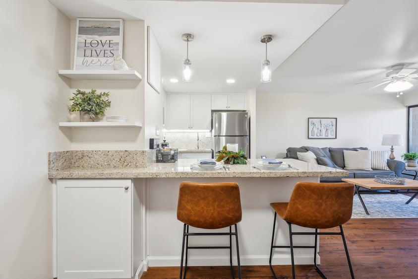 View of the kitchen bar and living of a Redwood Terrace home