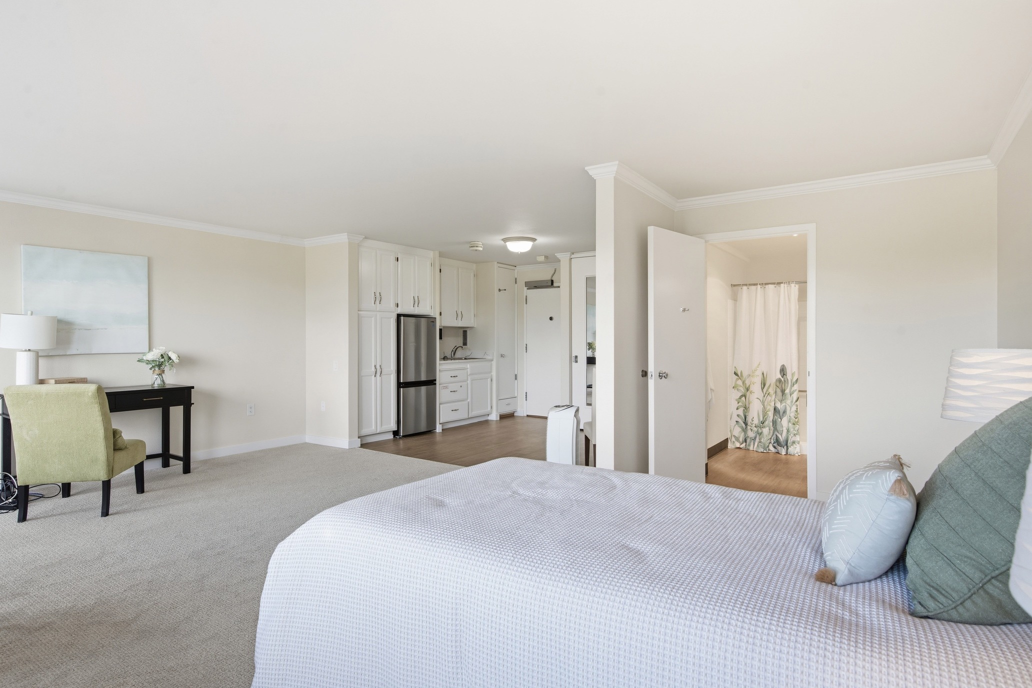 Studio apartment bedroom and kitchenette at Judson Park, a HumanGood community.