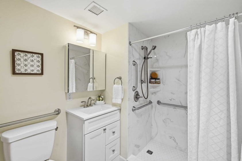 Accessible bathroom with walk-in shower and grab bars at Judson Park, a HumanGood community.