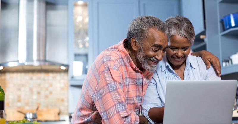 Smiling couple using laptop computer 