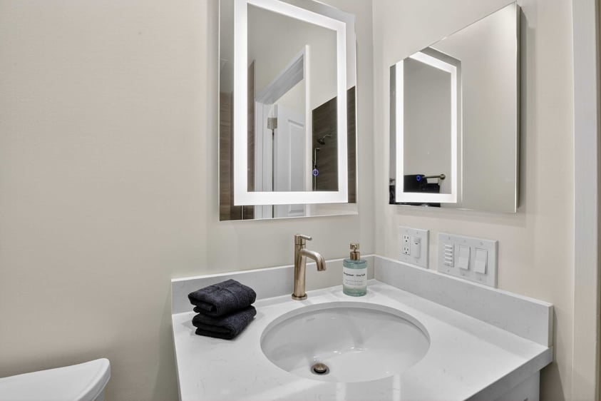 Bathroom vanity with lighted mirror in an assisted living residence at The Terraces of Los Gatos