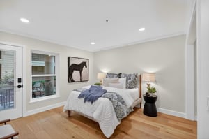 Bedroom at The Terraces of Los Gatos with a bed, hardwood floors, and recessed lighting.