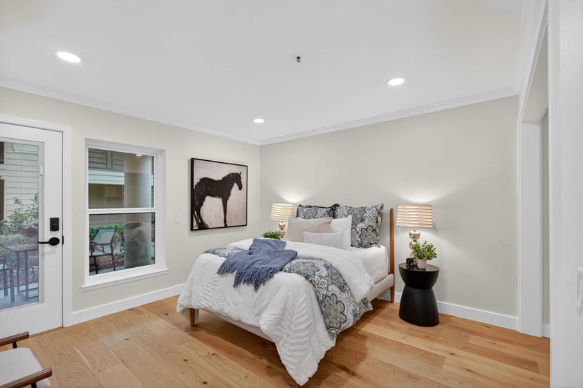 Bedroom at The Terraces of Los Gatos with a bed, hardwood floors, and recessed lighting.