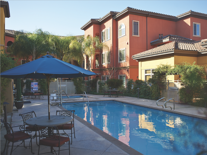 A pool in the middle of condo buildings. 