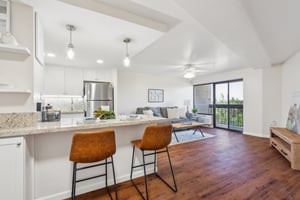 Rosewood kitchen with bar stools showing