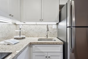 Rosewood corner kitchen shower, sink, and fridge