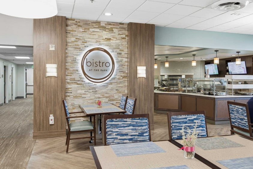 Judson Park’s Bistro at the Park dining area with neatly set tables, open service counters, and a casual, café-style atmosphere.