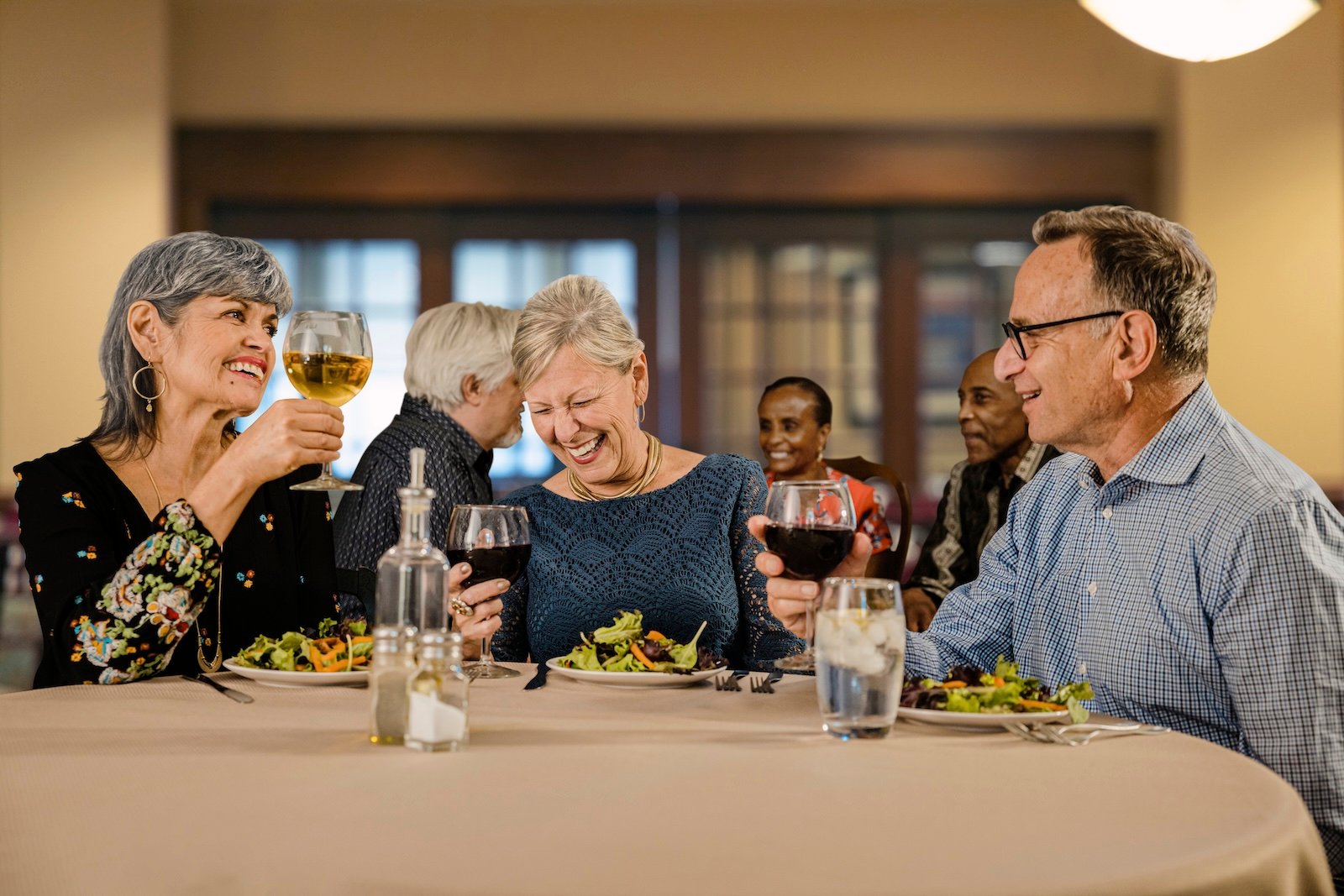 three residents at dinner with wine