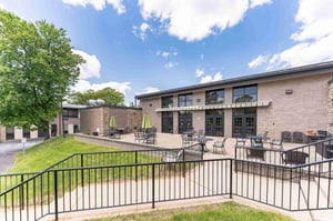 Spring Mill Pointe patio with tables, chairs and umbrellas