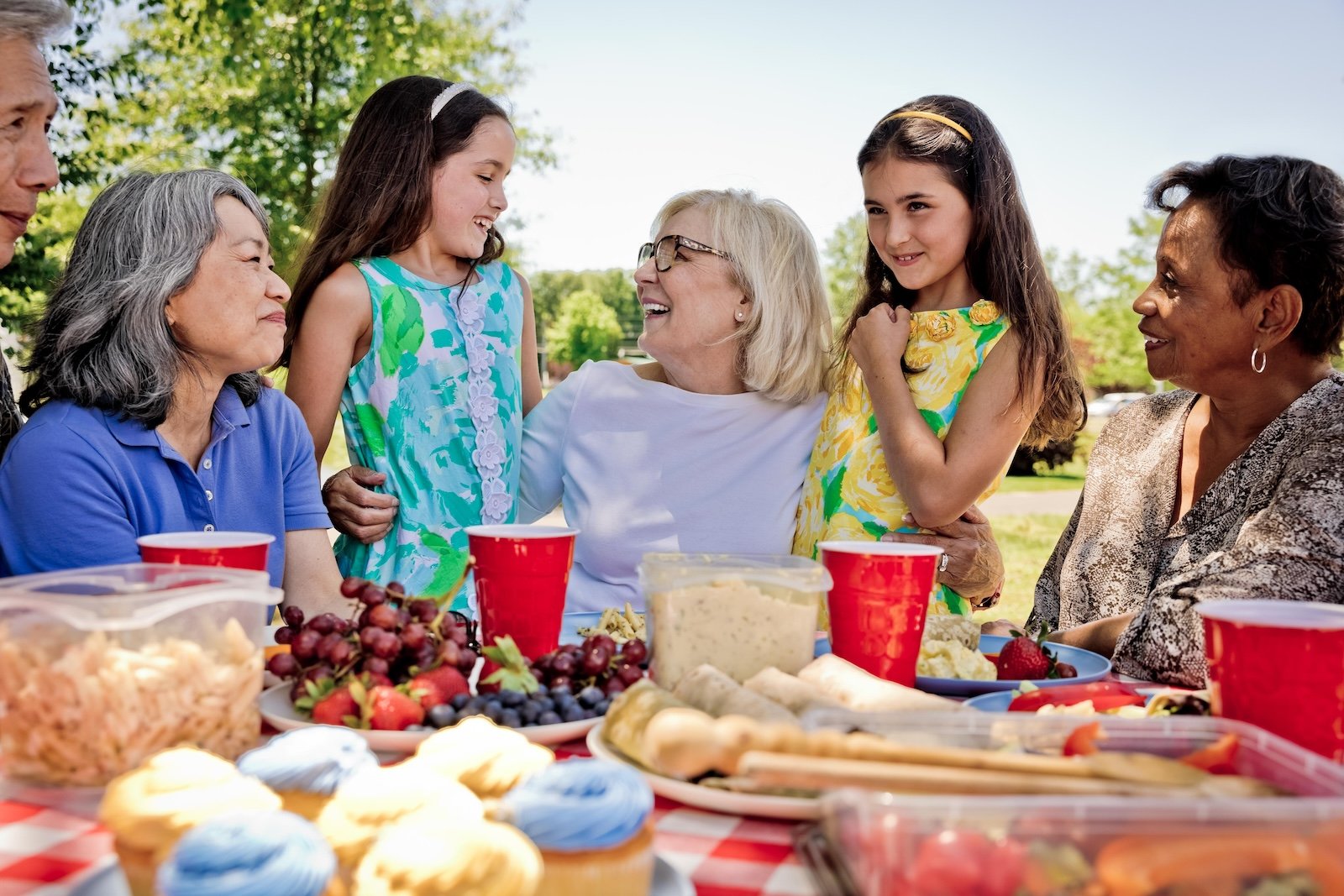older women having picnic with graddaughters