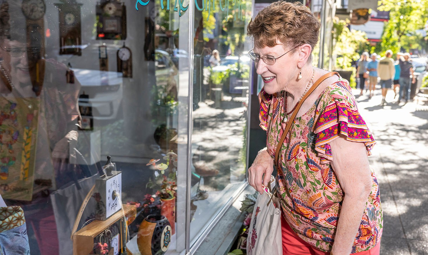 Senior woman window shopping at a downtown store