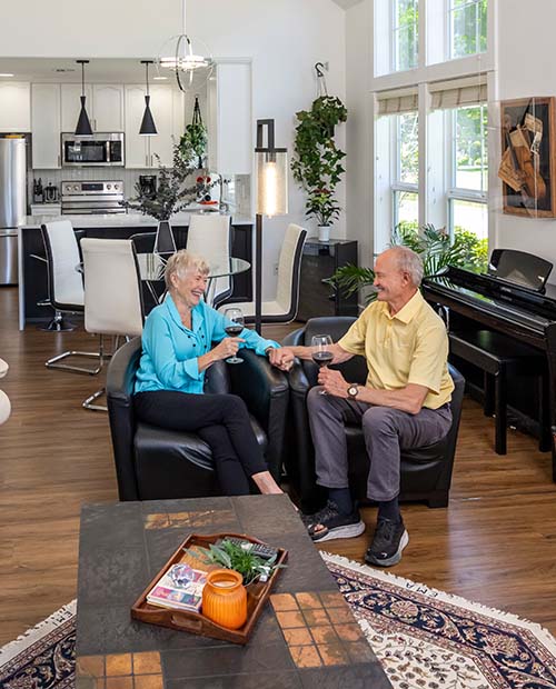 Senior couple enjoying wine in a spacious modern living room