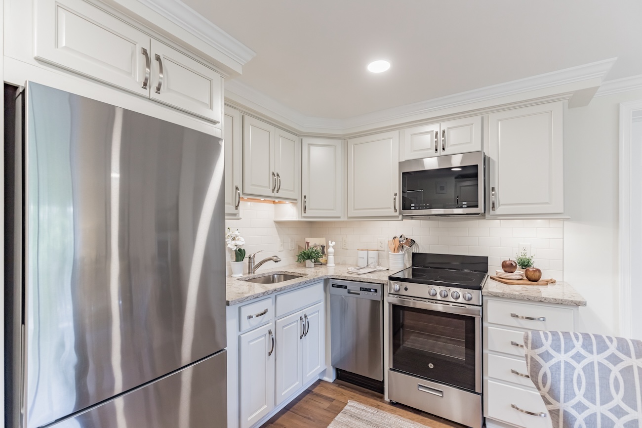 Kitchen with stainless steel appliances in apartment at The Mansion at Rosemont