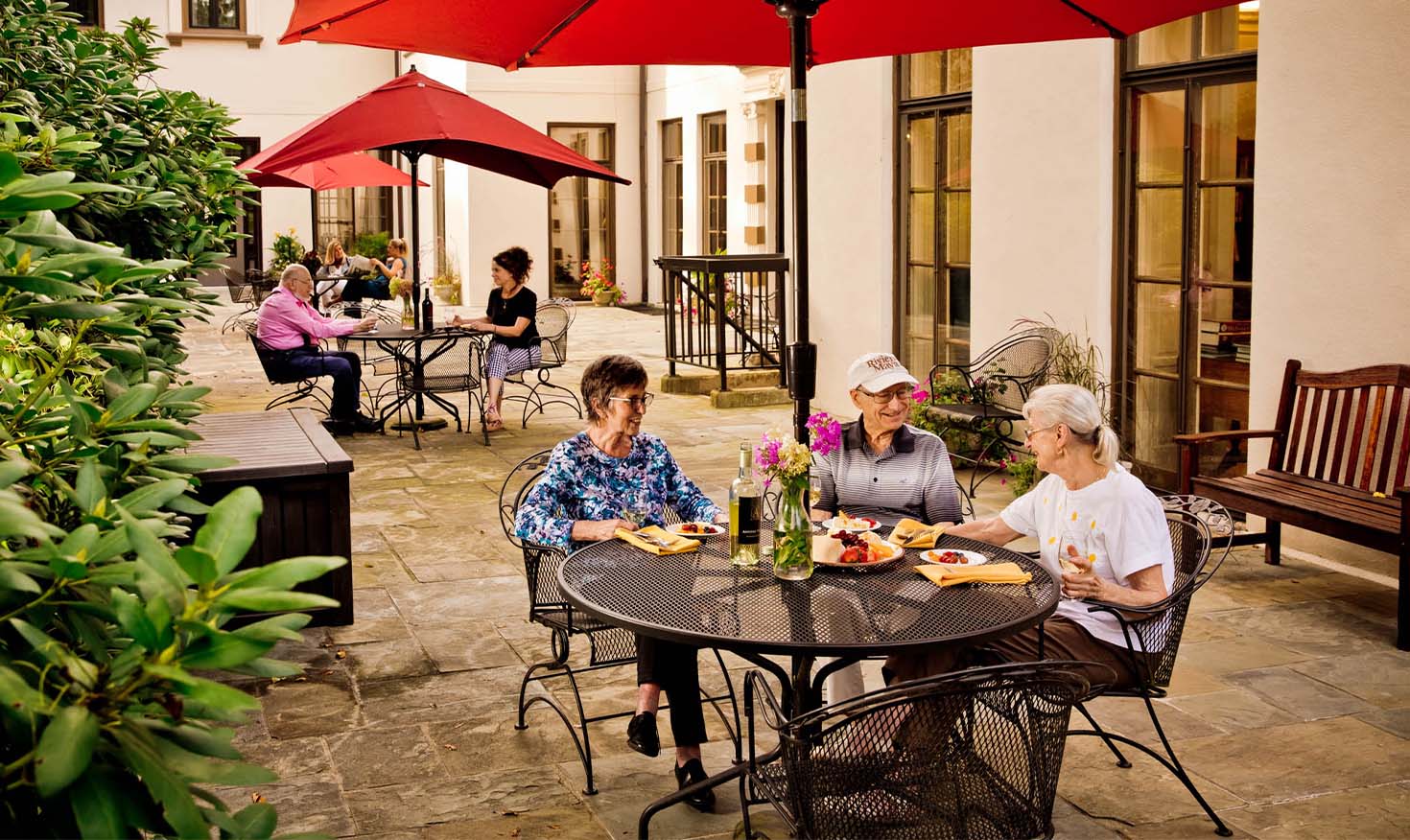 Seniors eating lunch outside on a patio