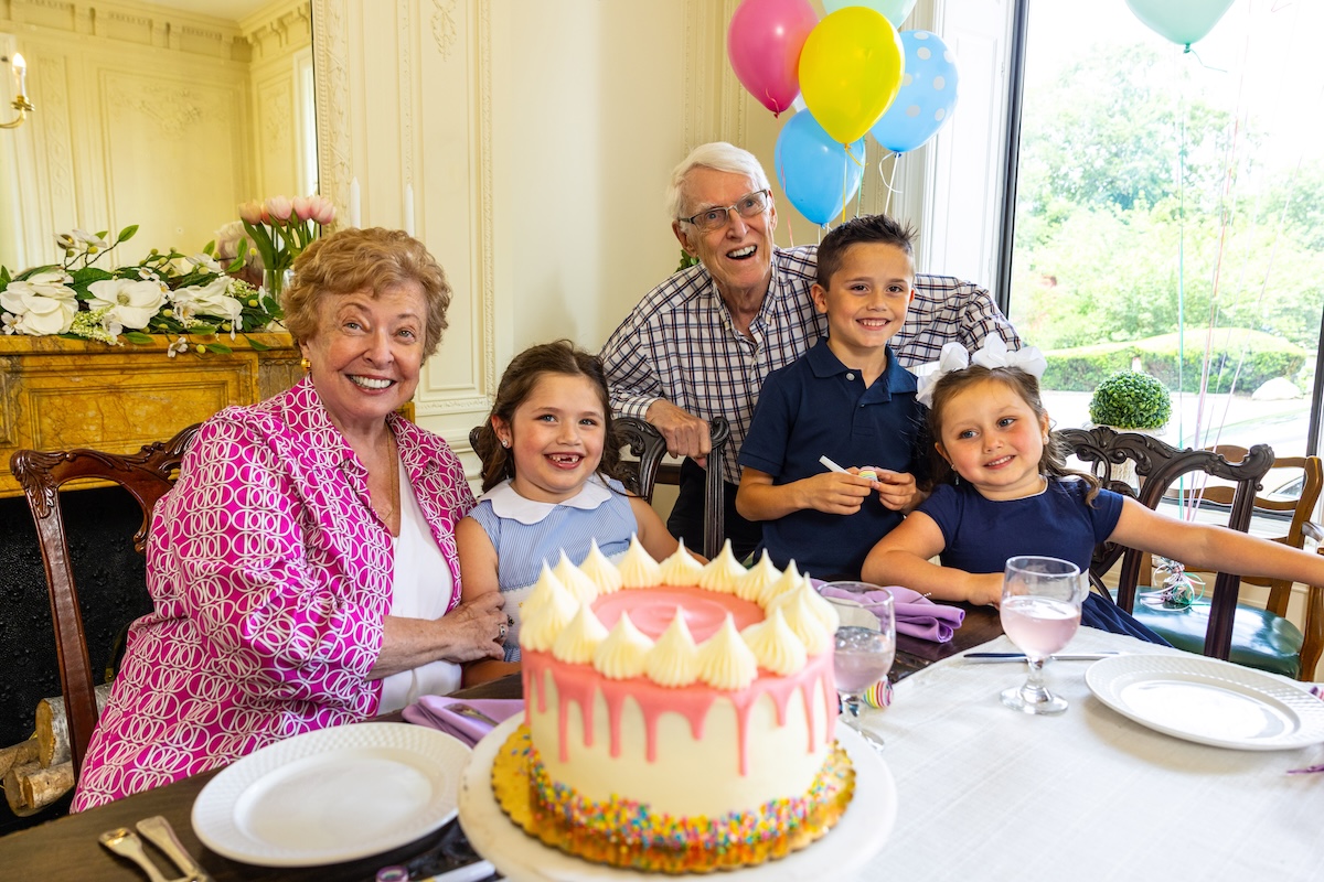 Senior couple celebrating birthday party with their three grandchildren