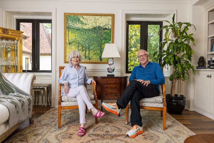 Senior couple sitting inside their living room