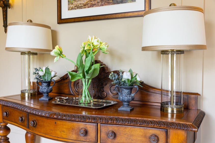 Side table with vases of flowers in an apartment at The Mansion at Rosemont