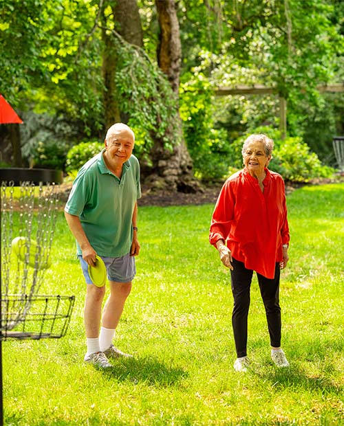 Senior couple playing disc golf 