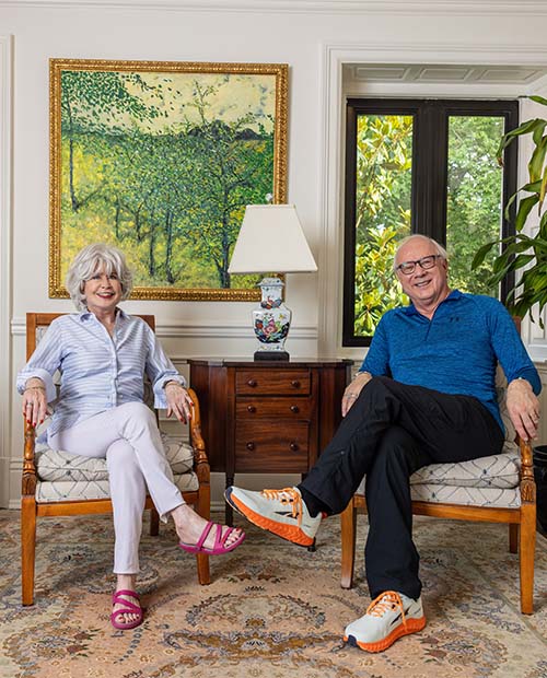 Senior couple sitting inside a luxury living room