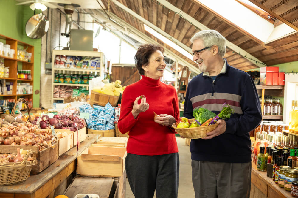 Senior couple shopping for produce