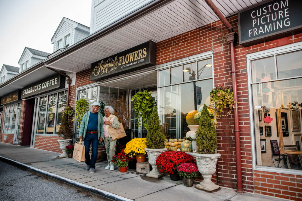 Senior couple walking out of Stephanie's Flowers of Chestnut Hill store