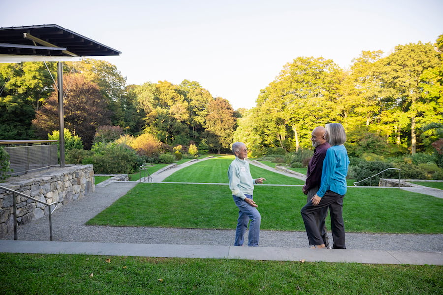 Three seniors talking outside in the Arnold Arboretum