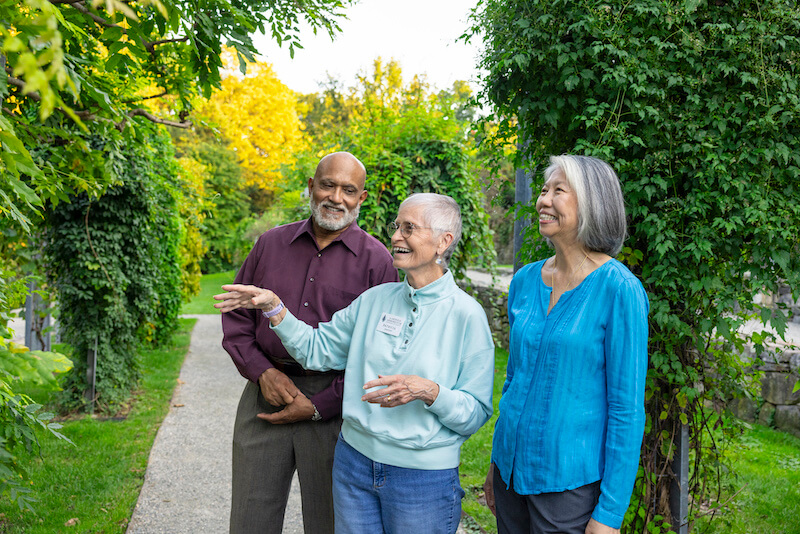 Three seniors walking through the Arboretum