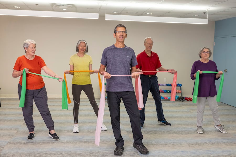 Group of seniors in a fitness class using resistance bands
