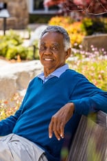 Senior man sitting on an outdoor bench