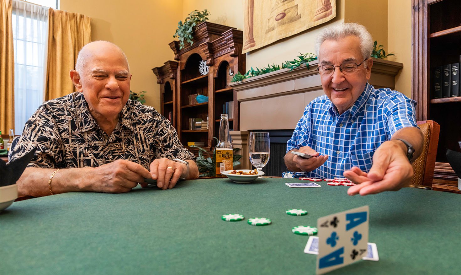 Two senior men playing poker