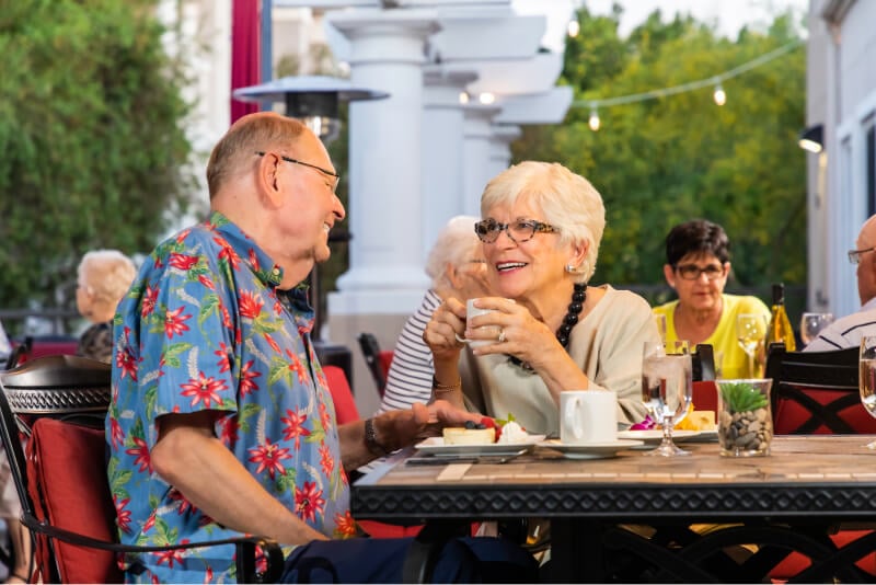 Senior couple at an outdoor dining table