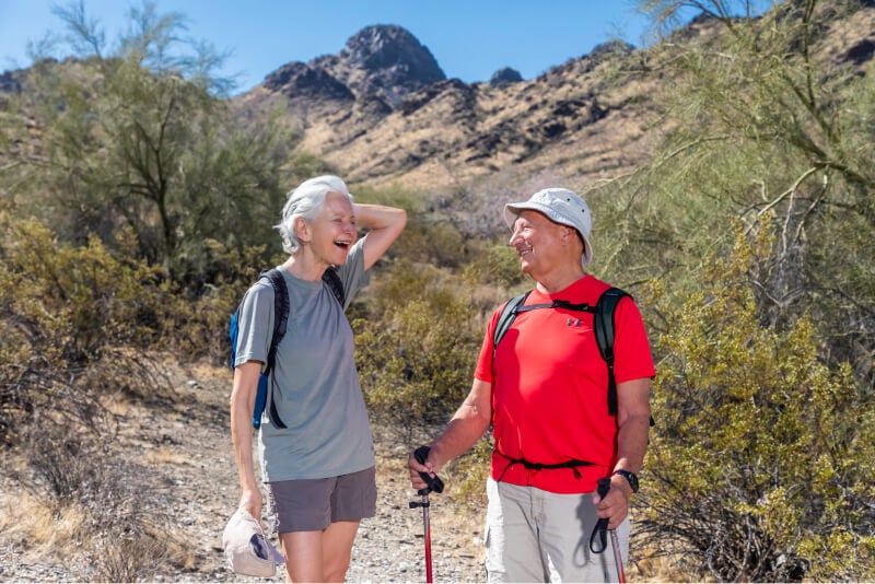 Senior couple on a hike with a mountain in the background
