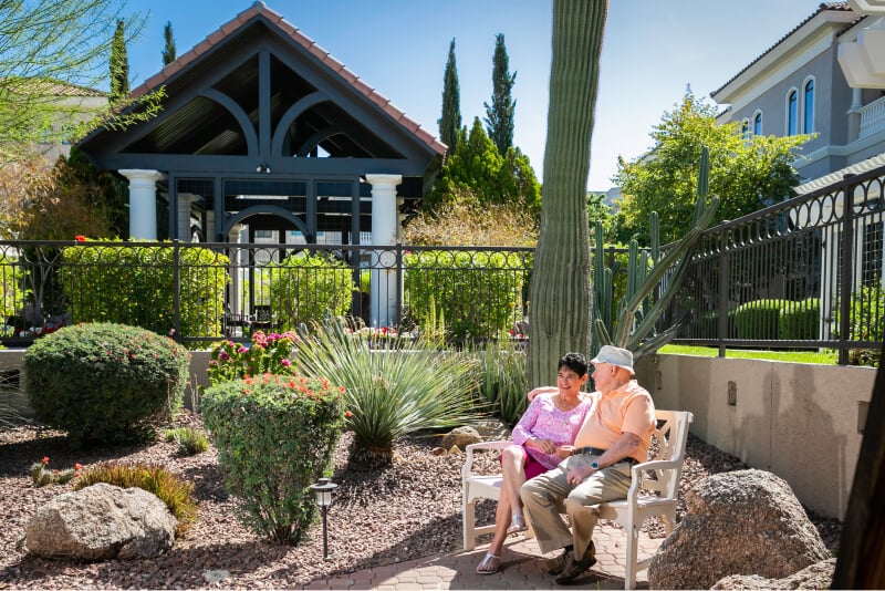 Senior couple sitting on bench outdoors