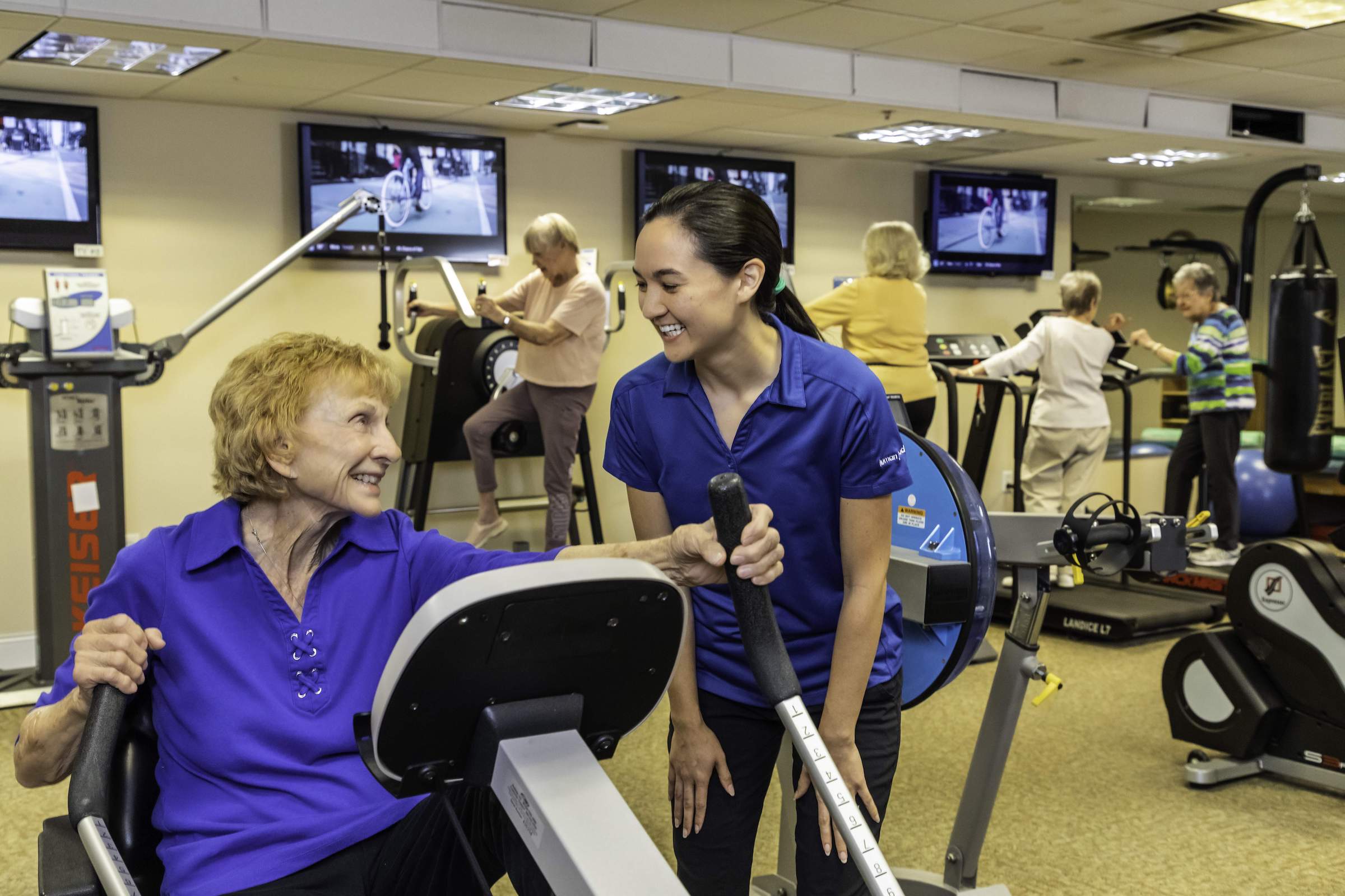 Senior woman working out with a personal trainer