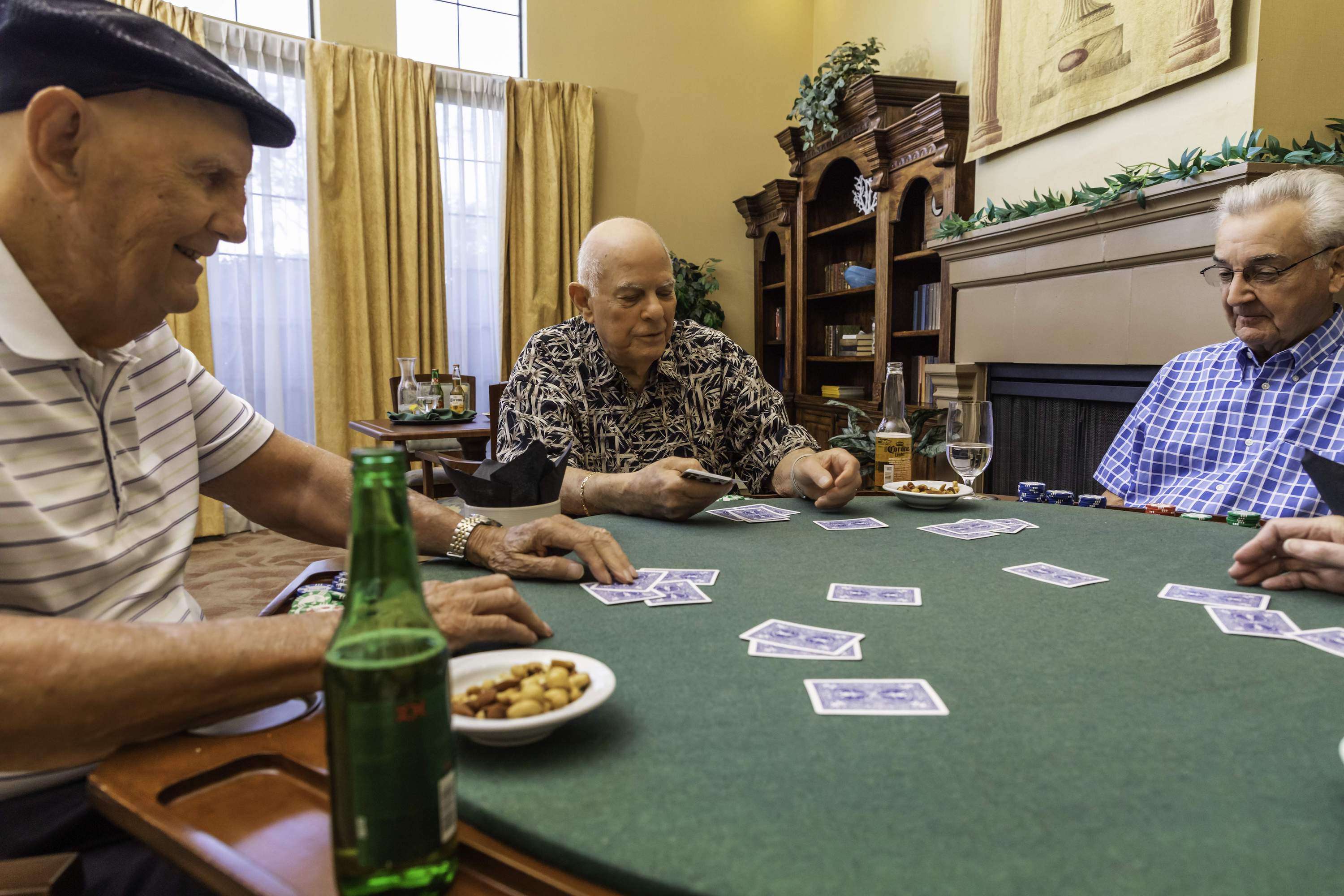 Three senior men playing cards