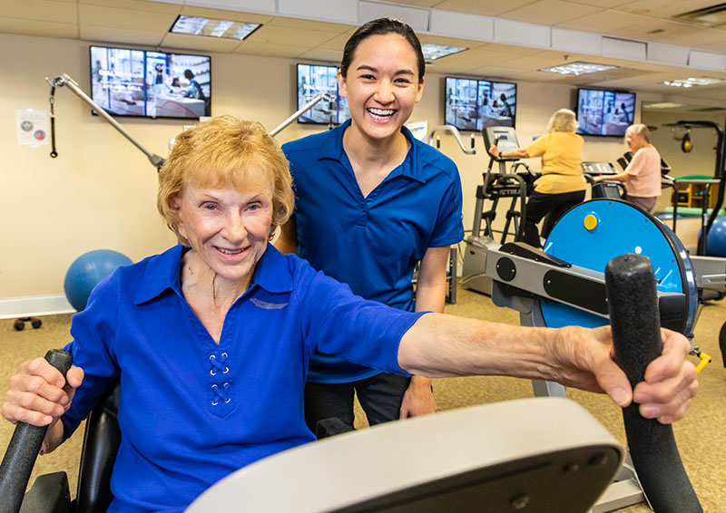 Senior woman working out with a personal trainer