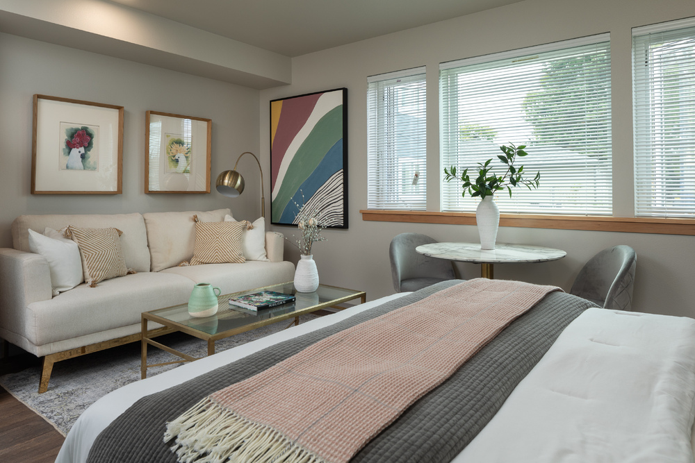 Bedroom with a sofa and framed artwork on the wall