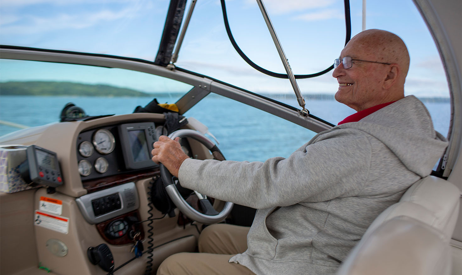 Senior man steering a boat on the water