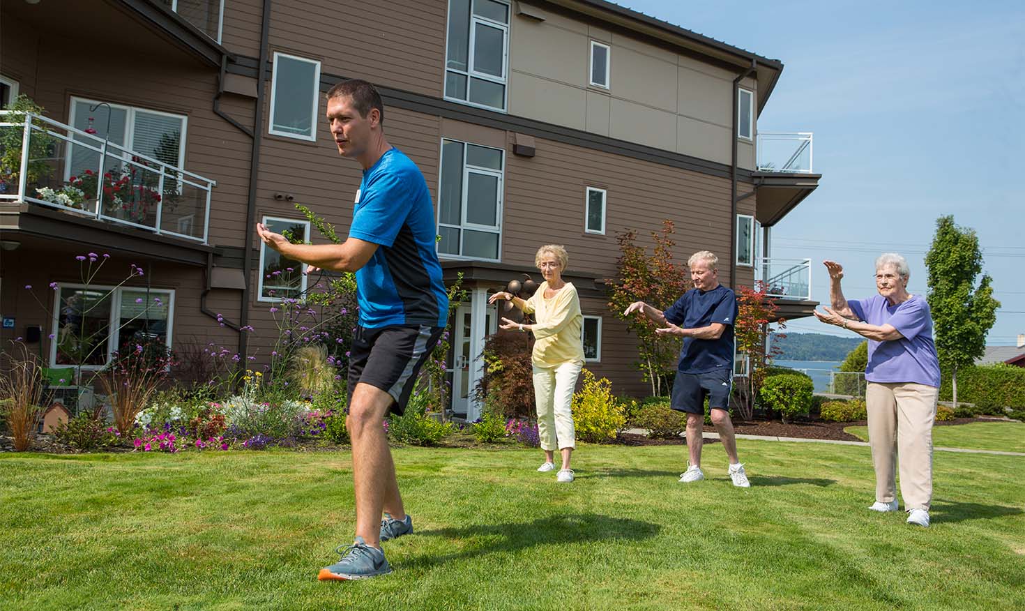 Two senior women and a senior man practicing tai chi with an instructor