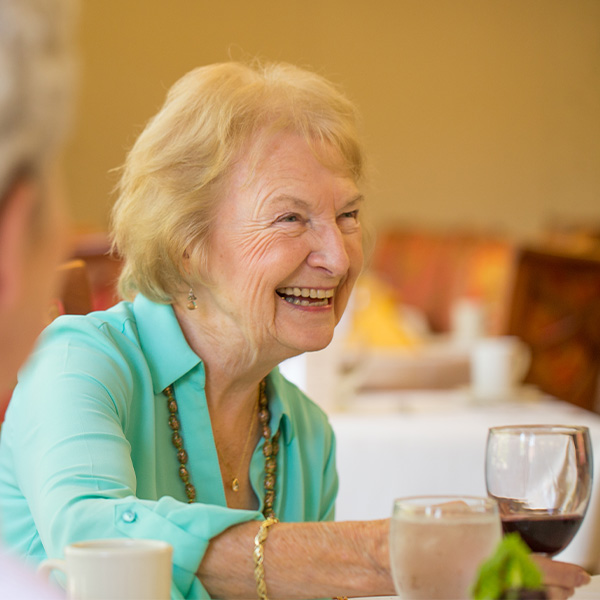 Smiling senior woman enjoying a glass of wine