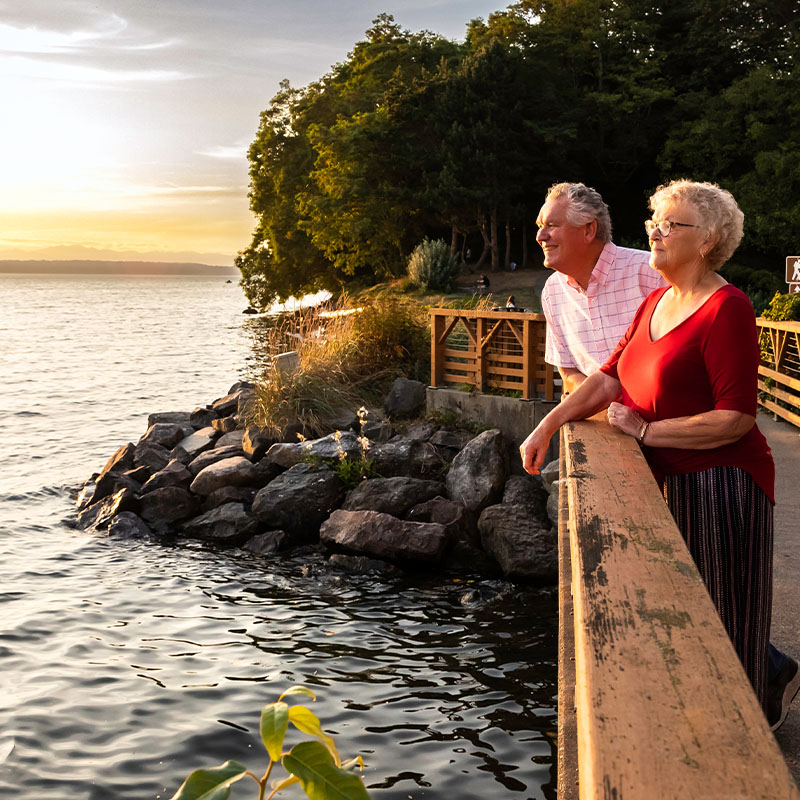 Senior couple on a bridge looking at the water