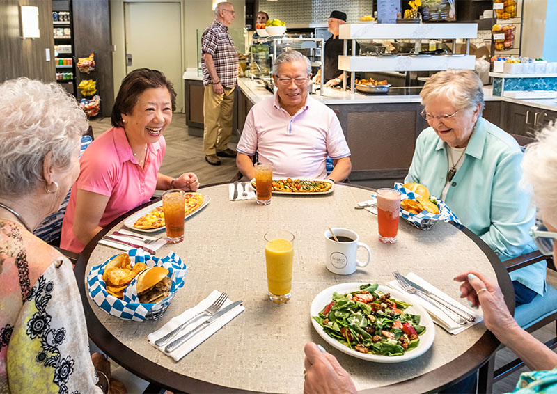 Group of senior friends having lunch in the community bistro