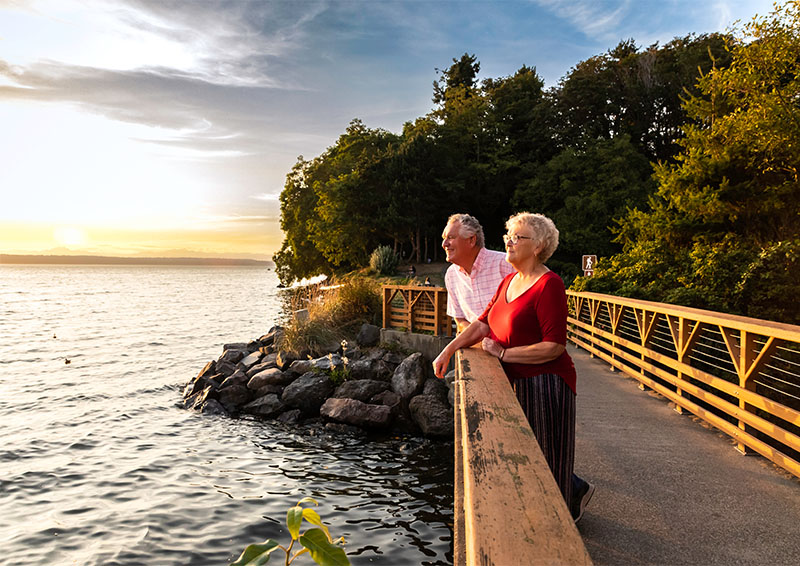 Senior couple on a bridge looking at the water