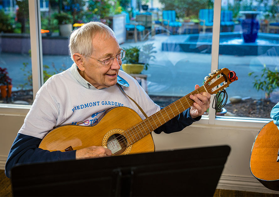 Senior man playing guitar