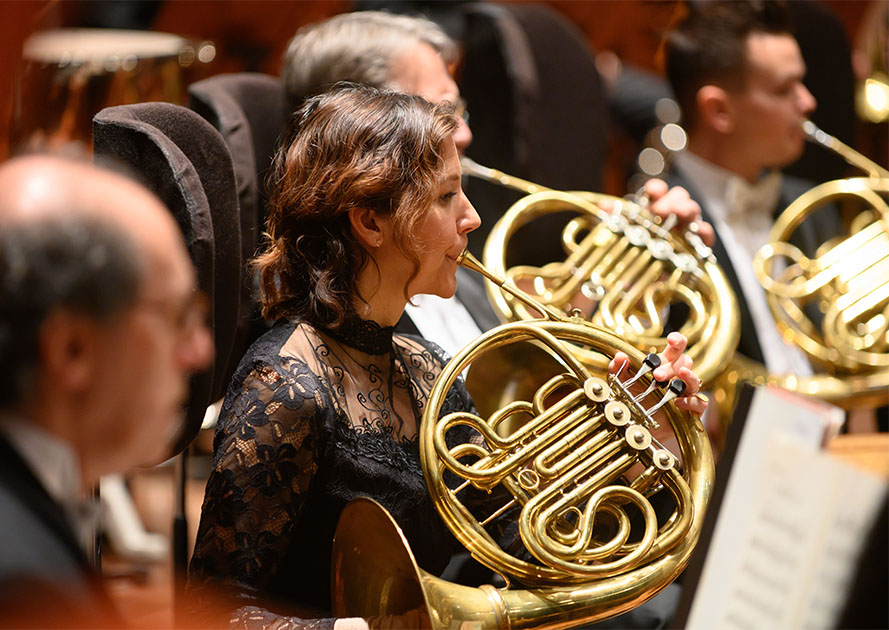 A member of the San Francisco Symphony playing the French horn