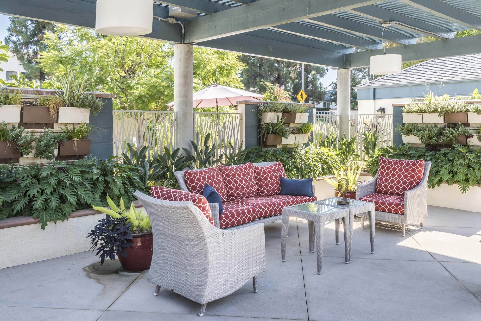 Outdoor patio furniture with red cushions at Redwood Terrace