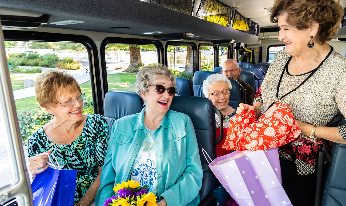 Senior friends on a shuttle bus after a shopping trip