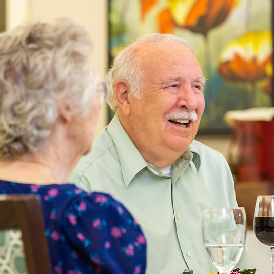 Seniors enjoying a meal in the dining room at Rosewood